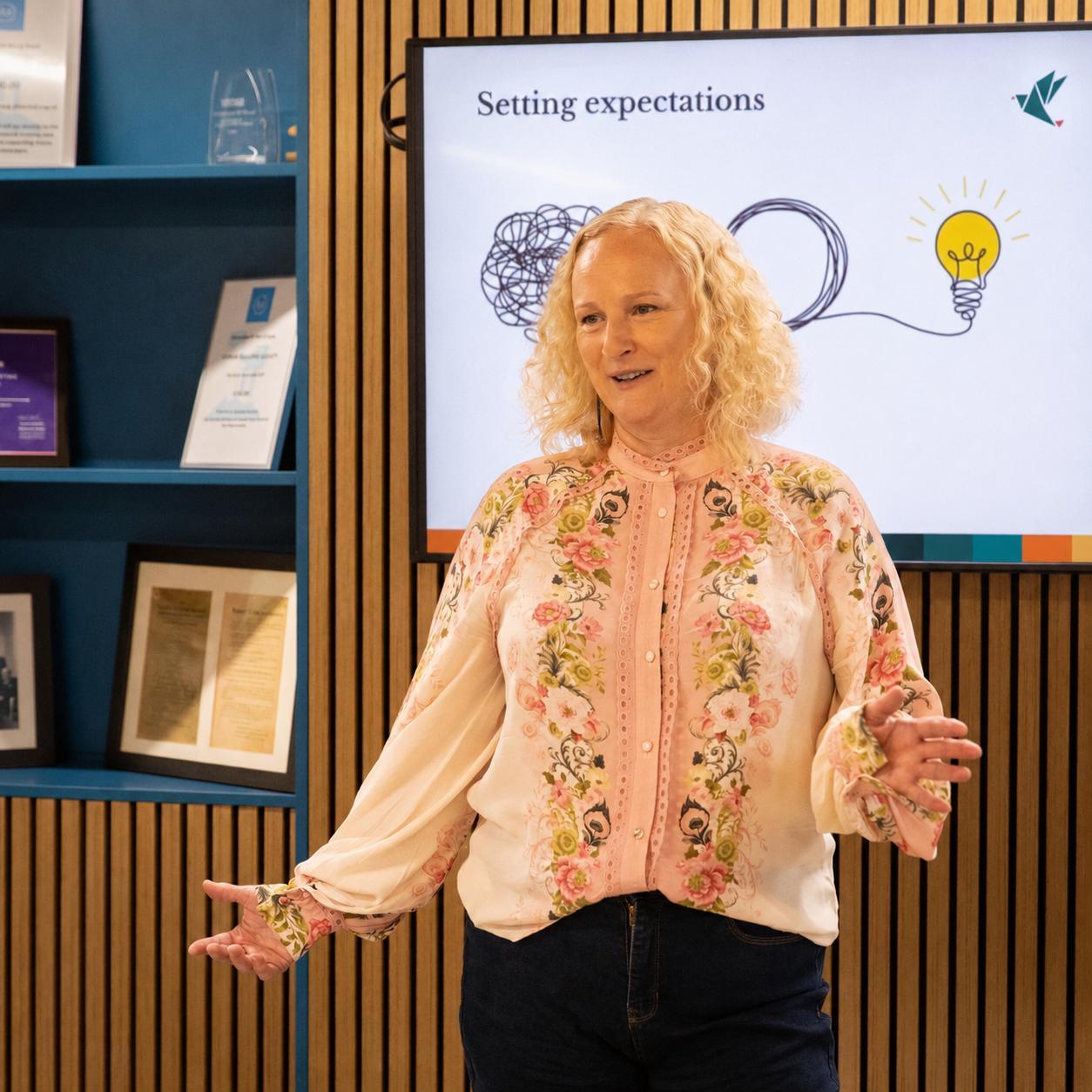 Kerry Sutcliffe presenting to the group, mid-gesture